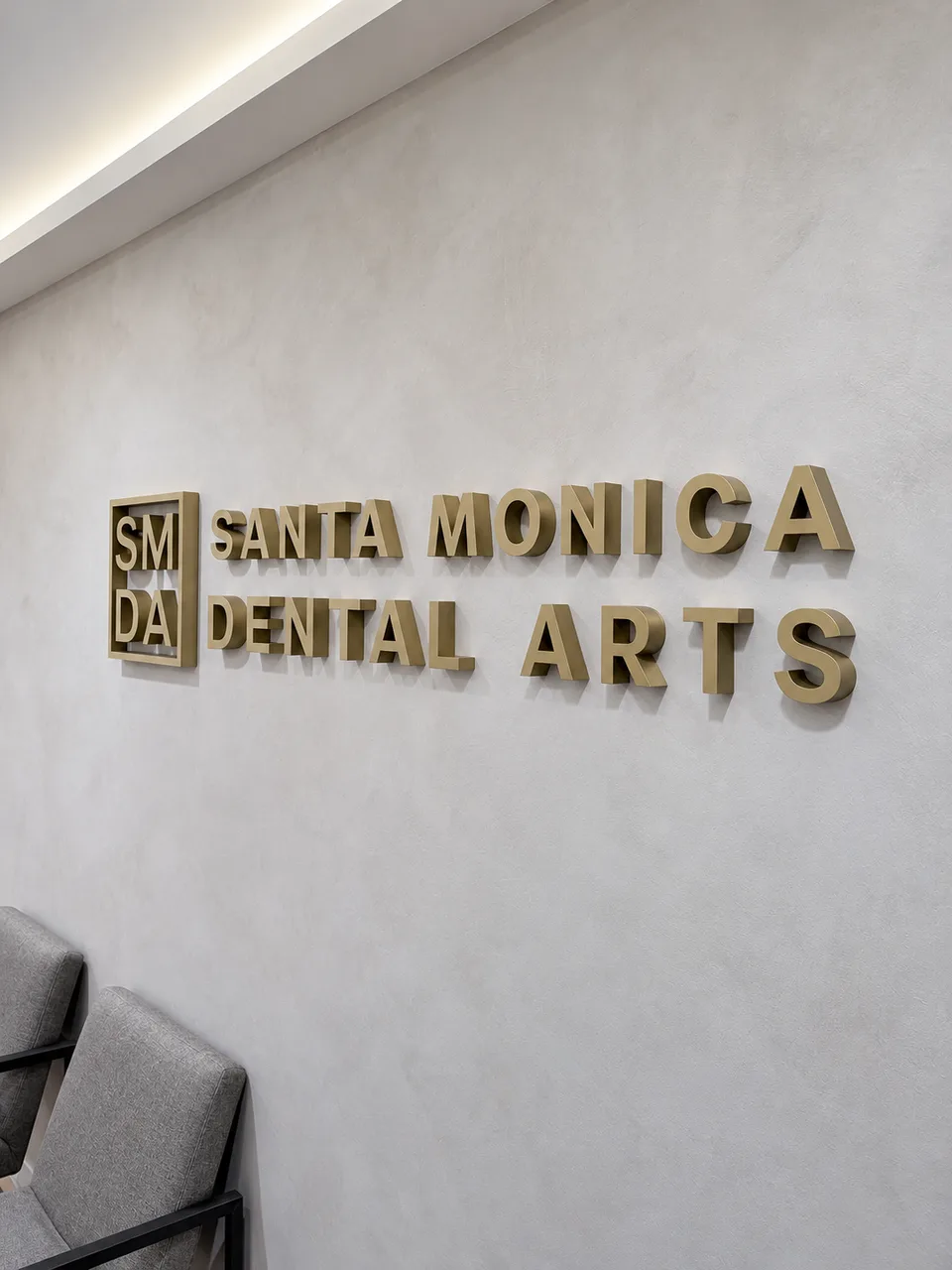 Gold dimensional Santa Monica Dental Arts reception lettering
