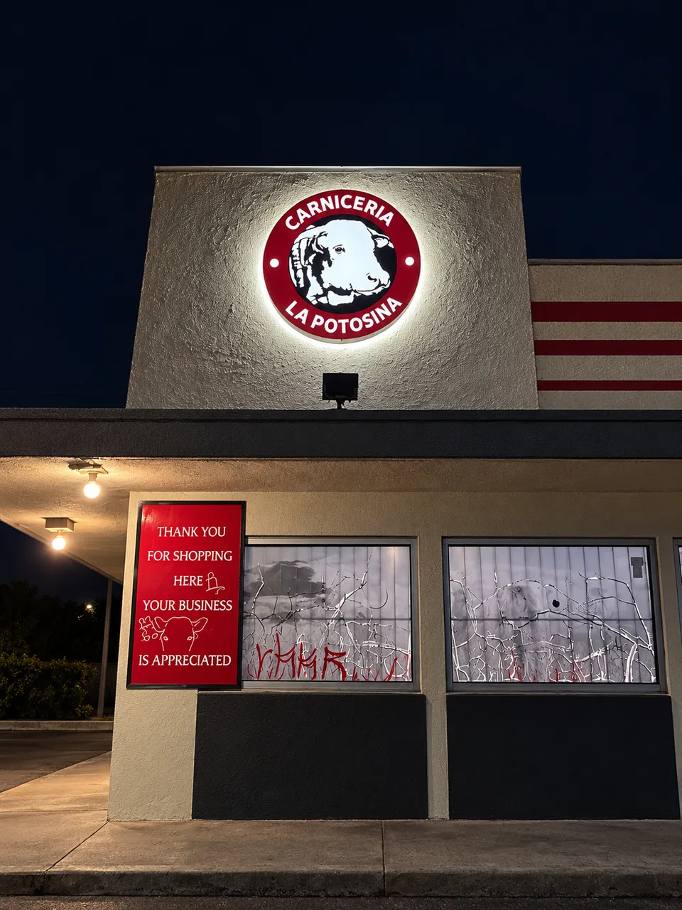 Carniceria La Potosina circular wall sign with a white halo