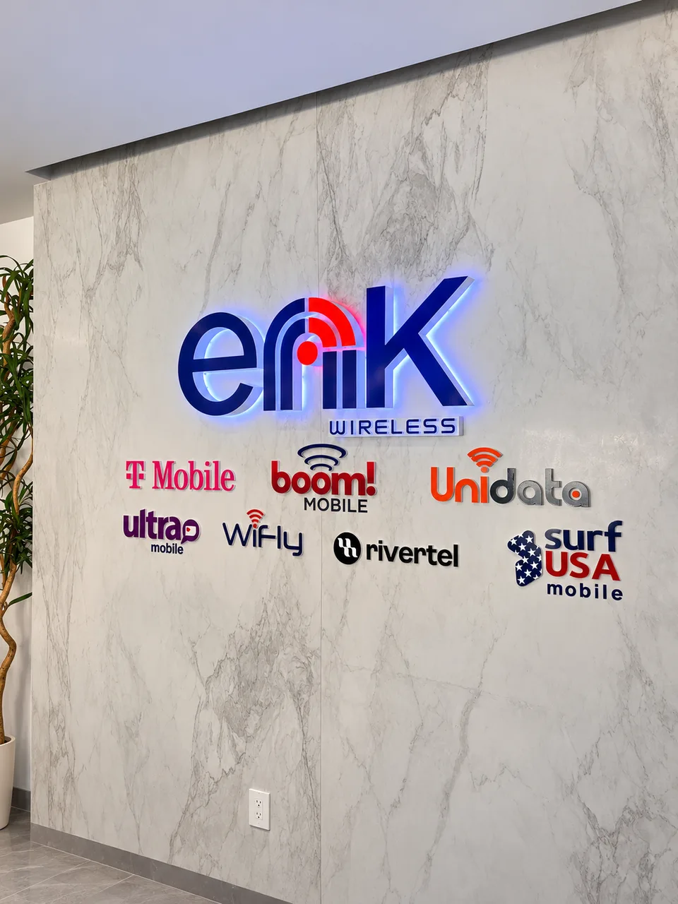 Erik Wireless illuminated lobby logo and applied brand lettering