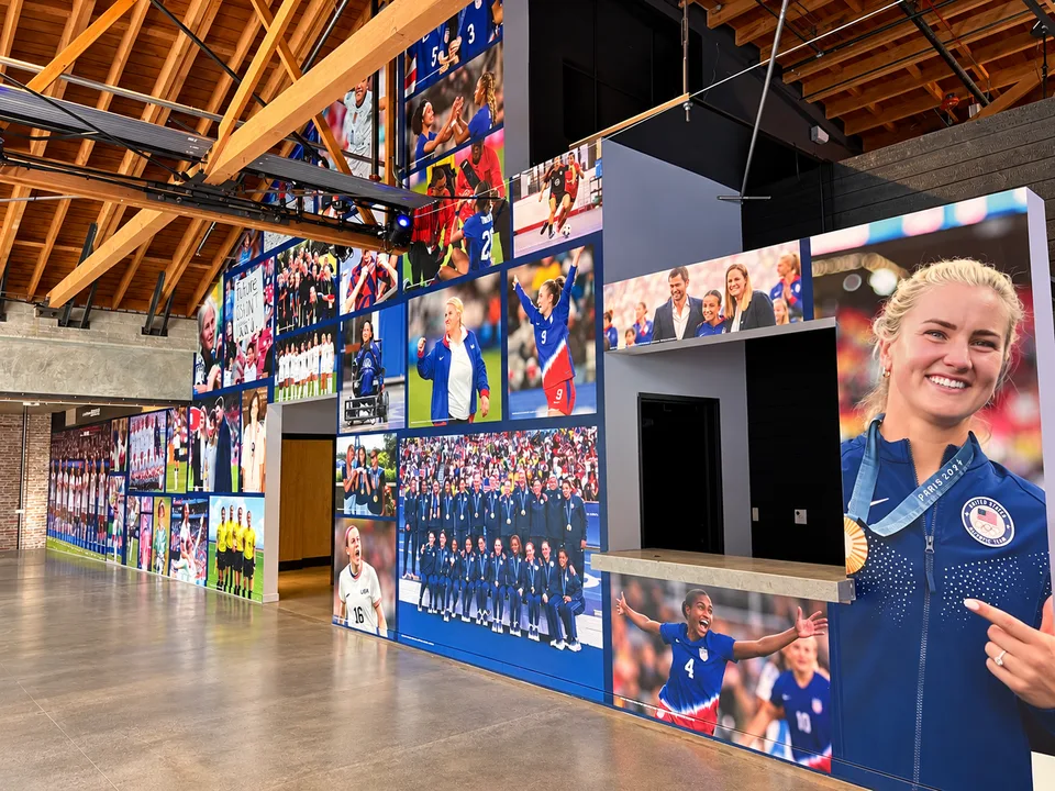 Large printed sports photo mural covering an interior feature wall