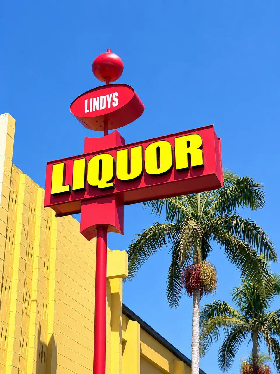 Lindy's Liquor red pole sign with raised yellow liquor letters