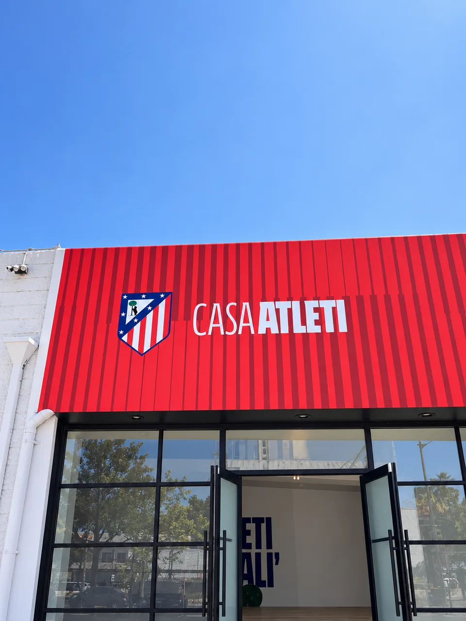 Casa Atleti raised exterior brand lettering and crest
