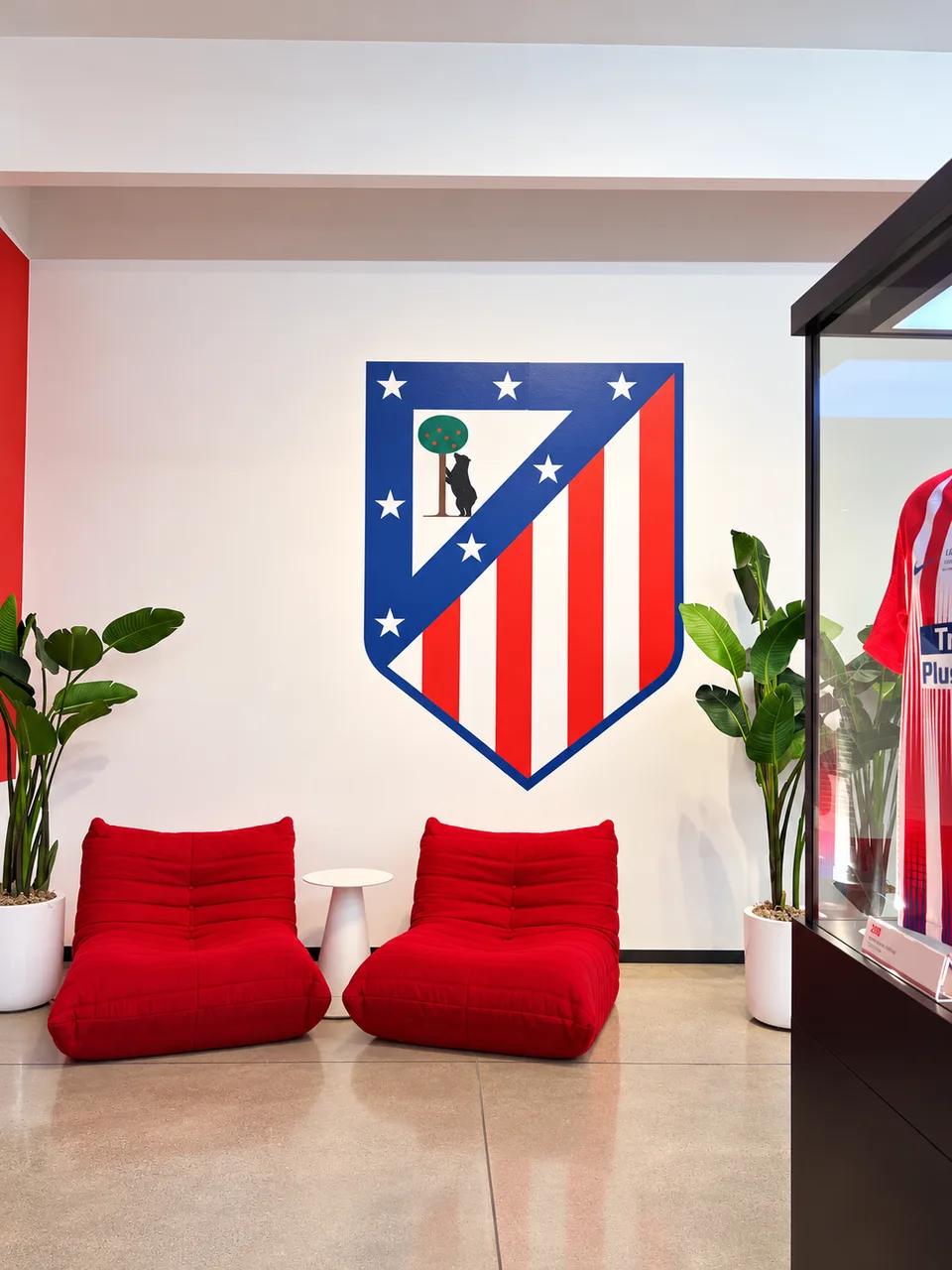 Atletico crest mounted on a white reception wall