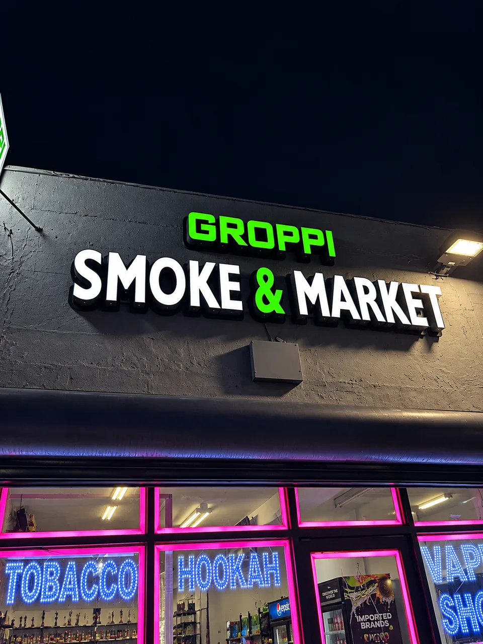 Groppi Smoke and Market illuminated storefront lettering